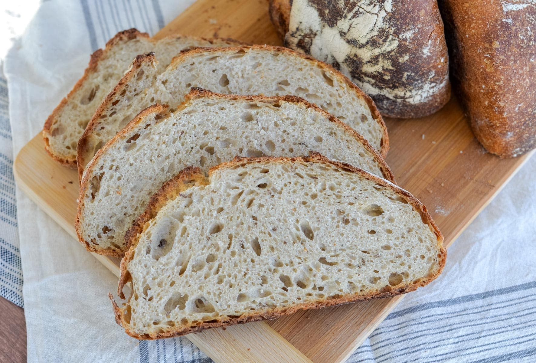 Sliced sourdough rye bread on a cutting board.