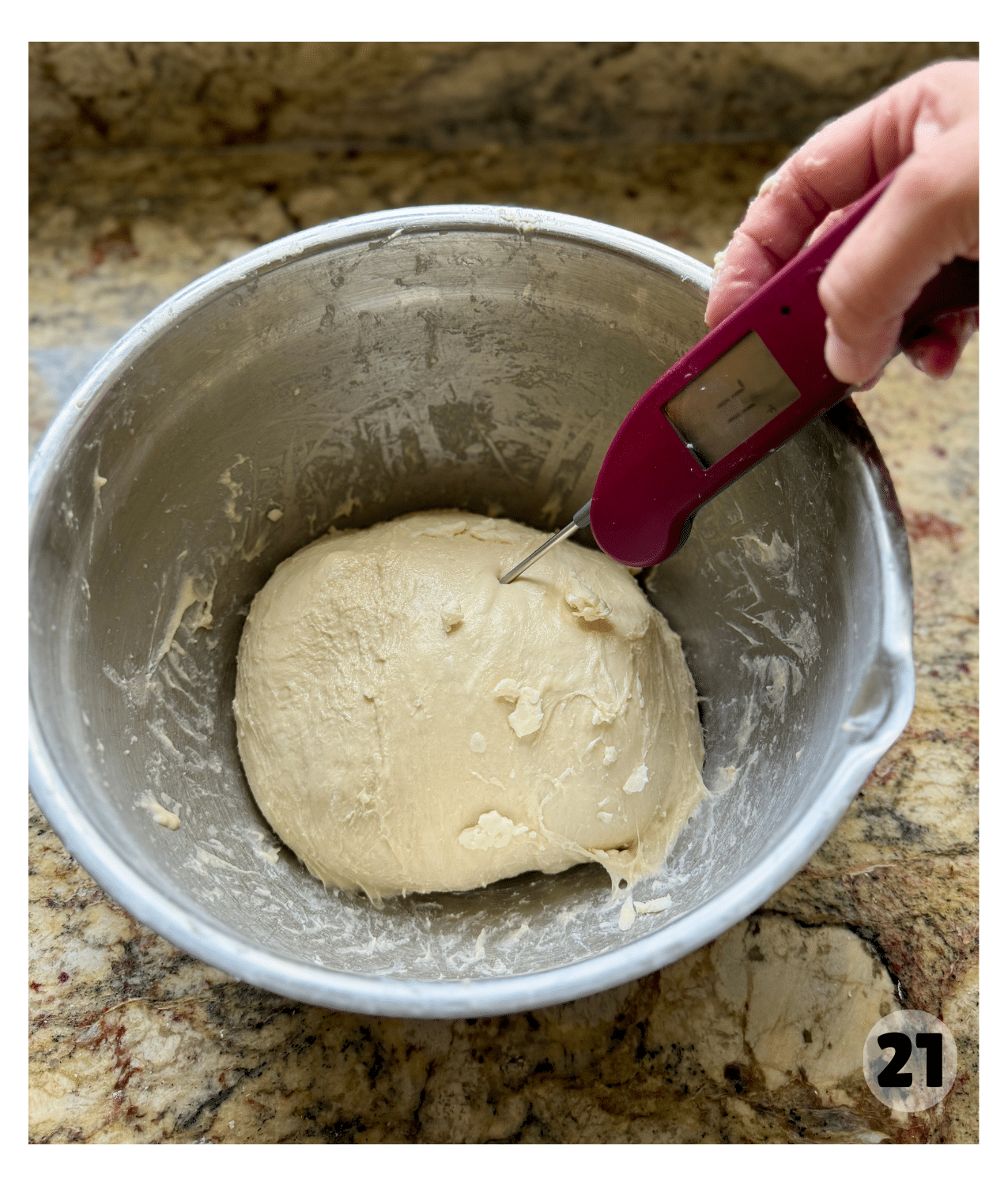 A thermometer sticks into the ball of dough, reading 71 degrees.