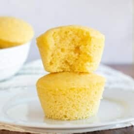 Sourdough cornbread muffins stacked on top of each other.