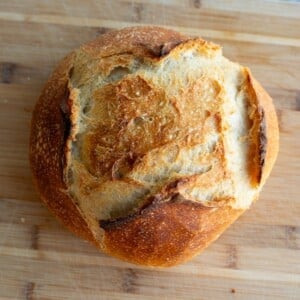 Sourdough discard loaf sitting on a cutting board.