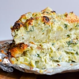 Spinach artichoke pull apart focaccia stacked on top of each other on a countertop.