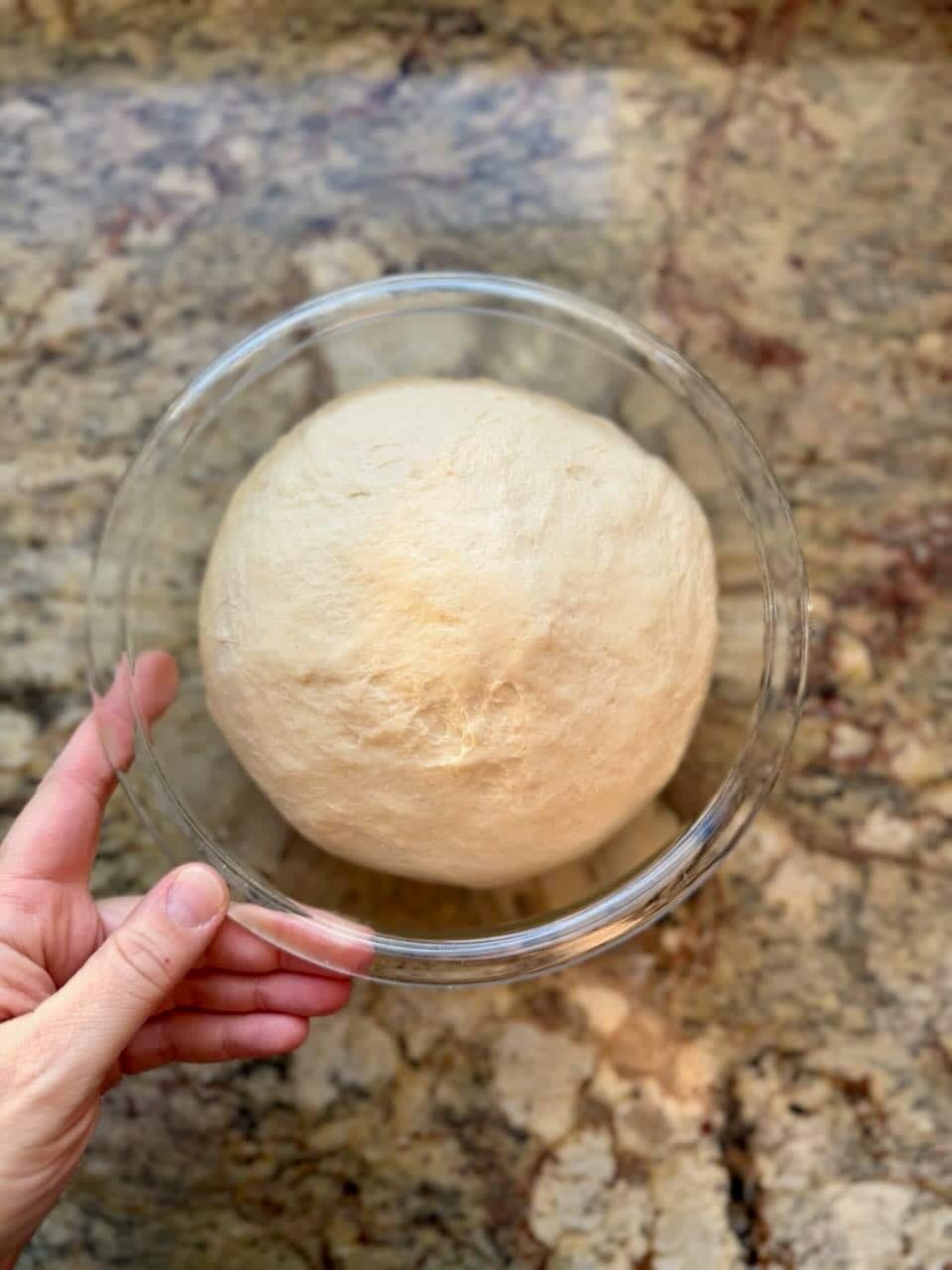 An overhead shot shows dough rising in a container.