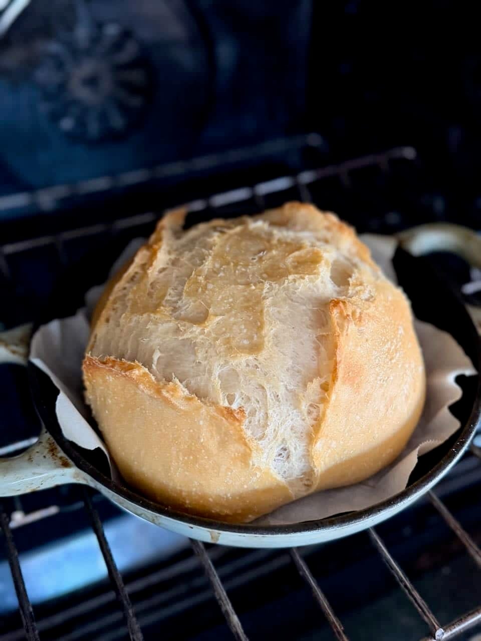 A partially baked loaf of bread bakes in the oven.