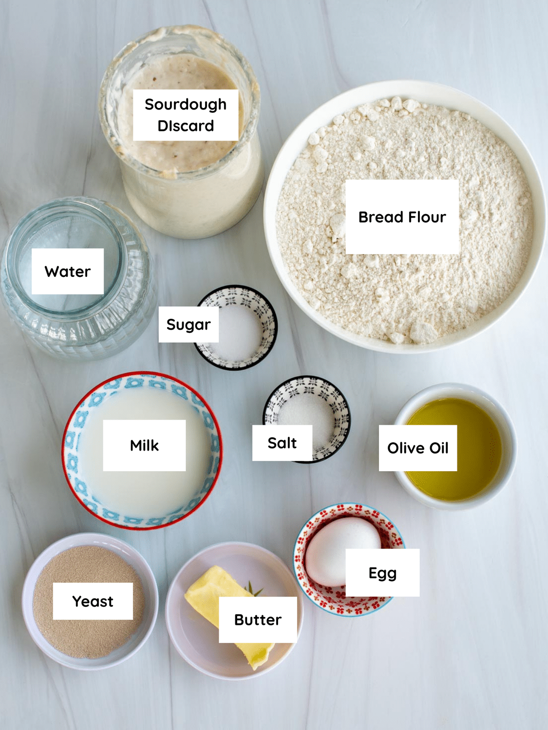 Ingredients for sourdough discard pide labeled on a table.
