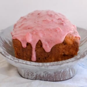 Sourdough discard strawberry bread loaf on a platter.