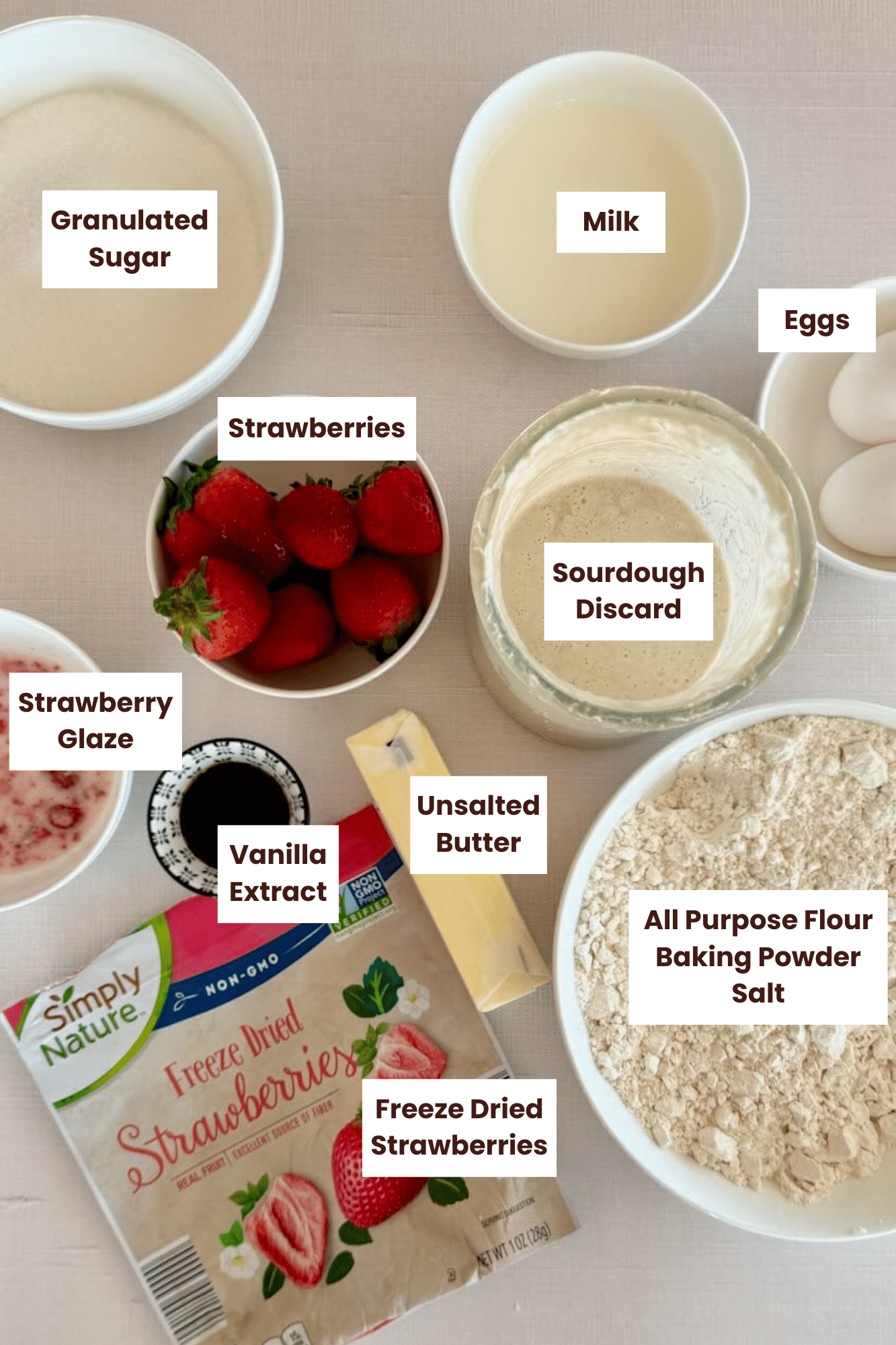 Ingredients in sourdough discard strawberry bread on a countertop labeled.